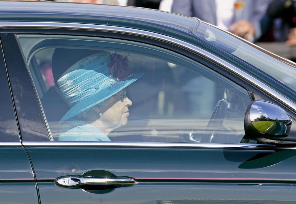 <p>Wearing a turquoise hat with a purple flower, the Queen left the Queen's Cup polo tournament, driving her Jaguar out of the event. </p>