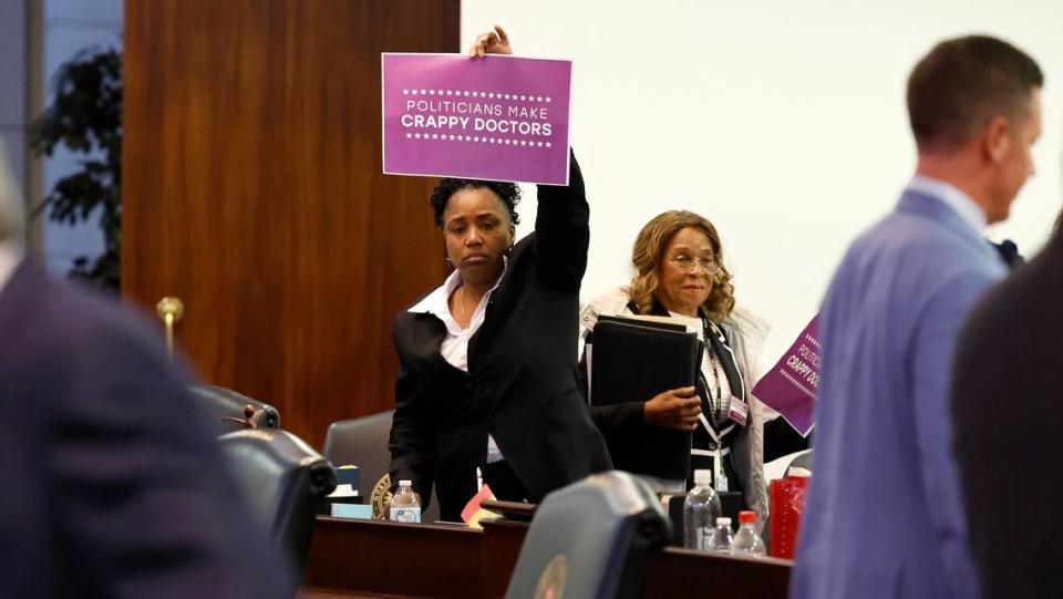 Democratic Senator Kandie Smith holds up a sign after the Senate passed SB 20, the “Care for Women, Children, and Families Act,” at the N.C. Legislature Building in Raleigh, N.C. Thursday, May 4, 2023.