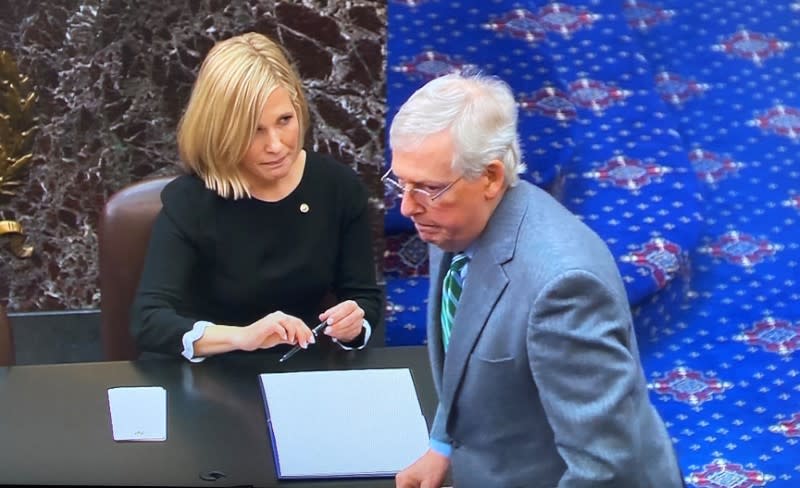 Senate Majority Leader McConnell signs oath book at start of Senate impeachment trial of President Trump at the U.S. Capitol in Washington