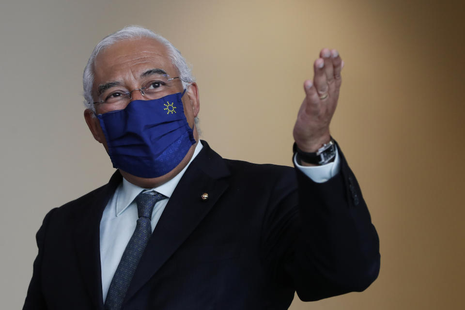 Portuguese Prime Minister Antonio Costa gestures after a group photo with EU Commissioners in Lisbon, Friday, Jan. 15, 2021. The Portuguese government has considered "without logic" the U.K.'s decision to ban travel from Portugal to ensure a new variant of COVID-19 found in Brazil doesn't derail the country's vaccination program. (AP Photo/Armando Franca)