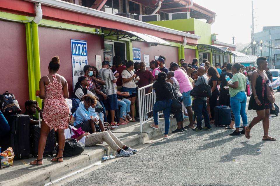 People queue outside a bus station in Scarborough, Trinidad and Tobago, before the arrival of hurricane Beryl (AFP via Getty)