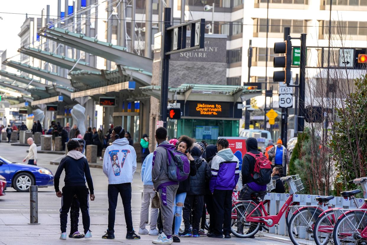 Teens hang out near Government Square at Walnut Street, Downtown, on Thursday.