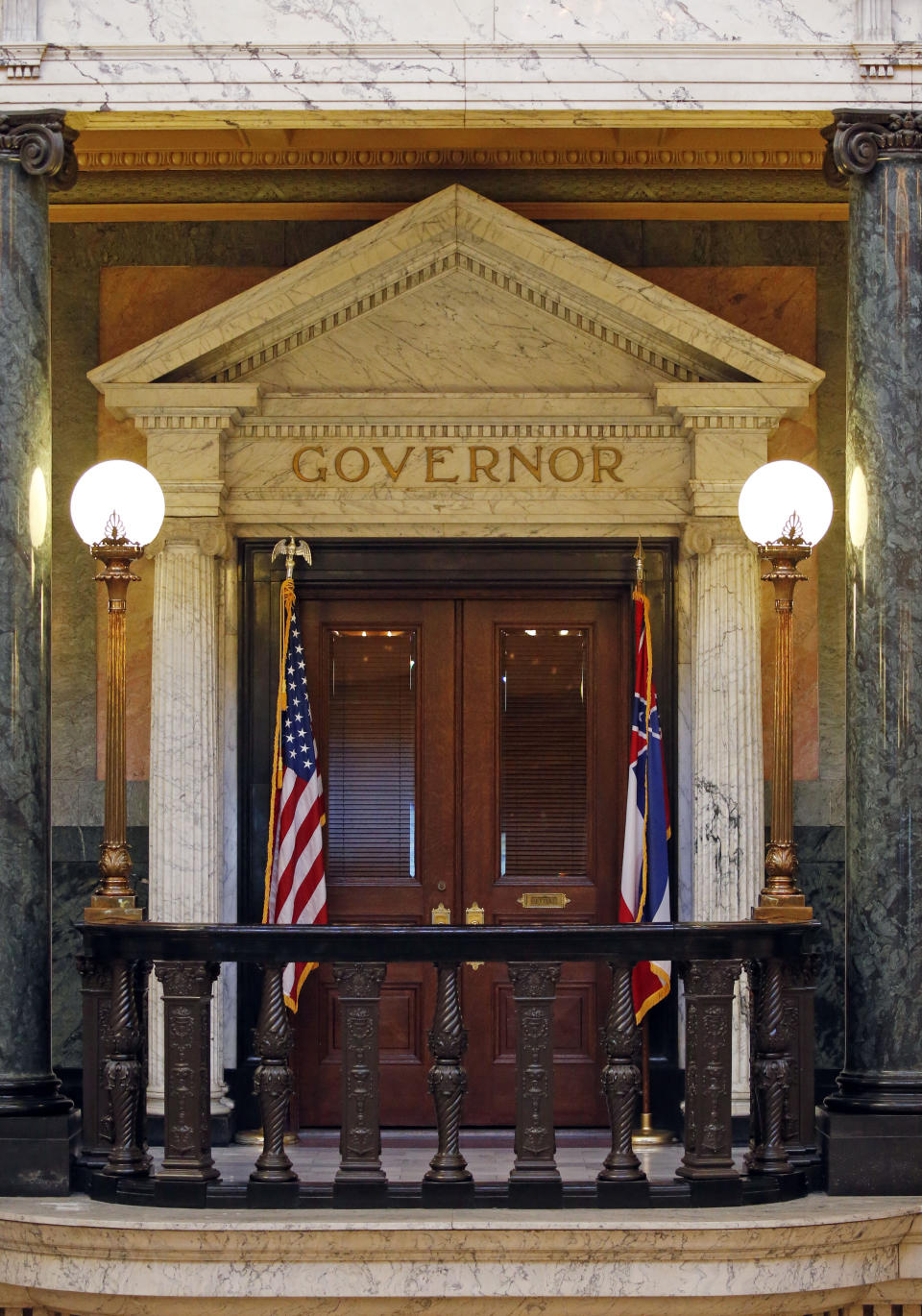 The title of governor rests above the entrance to the office at the Mississippi State Capitol in Jackson, Miss., Wednesday, May 29, 2019. A federal lawsuit being filed Thursday, seeks an injunction in this year's elections against using what it describes as a "racist electoral scheme" that "intentionally and effectively dilutes African American voting strength." To win elections in Mississippi, candidates for statewide offices must receive a majority of the popular vote and win at least 62 of the 122 state House of Representatives districts. Mississippi is the only state that requires statewide candidates to win in the majority of state House districts. (AP Photo/Rogelio V. Solis)