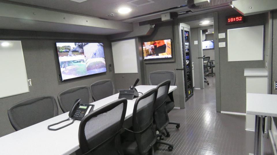 The inside of mobile command vehicles can be like nice, fully functional office space complete with air conditioning. Pictured is a vehicle that appears to have two office areas and cameras showing what's outside the vehicle on large live video screens.