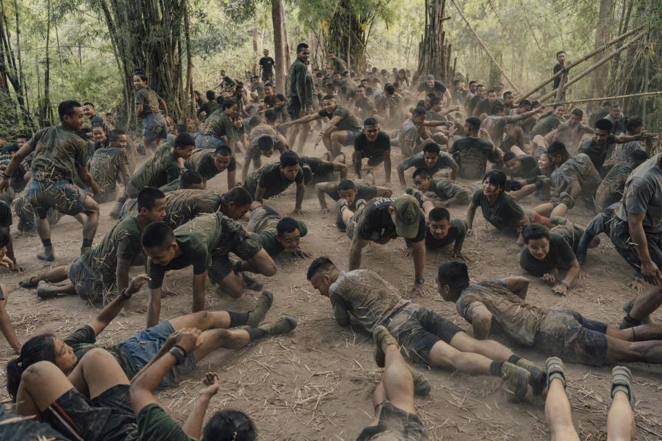 Eubank (center, in hat) leads trainees through a pushup session as part of a “Ranger Run” they must complete to graduate. In an unusual arrangement, FBR and ethnic resistance groups cooperate, drill, and work out side by side under Eubank’s direction.