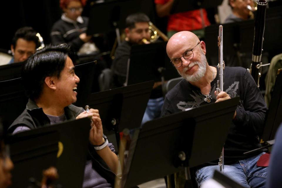 Carlos Maulini, 61, right, shares a light moment with Joey Orpilla, 30, while rehearsing.