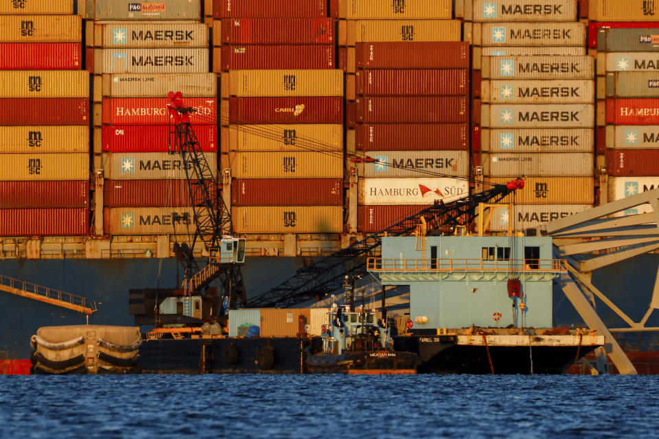 Cranes stand by as the wreckage of the Francis Scott Key Bridge rests on the container ship Dali, Saturday, March 30, 2024, in Baltimore. (AP Photo/Julia Nikhinson)