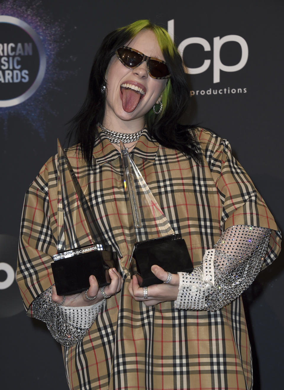 Billie Eilish poses in the press room with the award for new artist of the year and favorite alternative rock artist at the American Music Awards on Sunday, Nov. 24, 2019, at the Microsoft Theater in Los Angeles. (Photo by Jordan Strauss/Invision/AP)