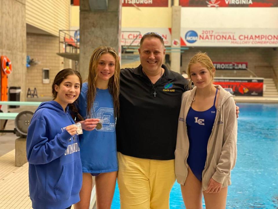 Lexington Catholic diving coach Jamie Palumbo poses with his girls team, from left, Yasemine Stephens, Sydney Leslie and Grace George after the Region 8 Diving Championships at the University of Louisville on Monday, Feb. 5, 2024. Photo provided