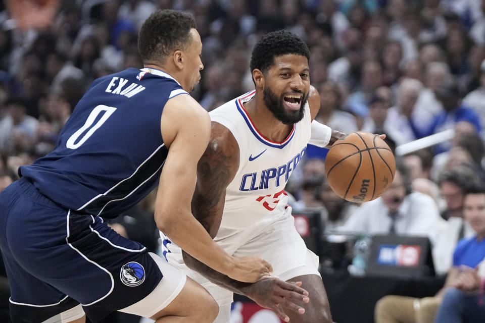 Los Angeles Clippers forward Paul George, right, tries to drive by Dallas Mavericks guard Dante Exum during the first half in Game 5 of an NBA basketball first-round playoff series Wednesday, May 1, 2024, in Los Angeles. (AP Photo/Mark J. Terrill)