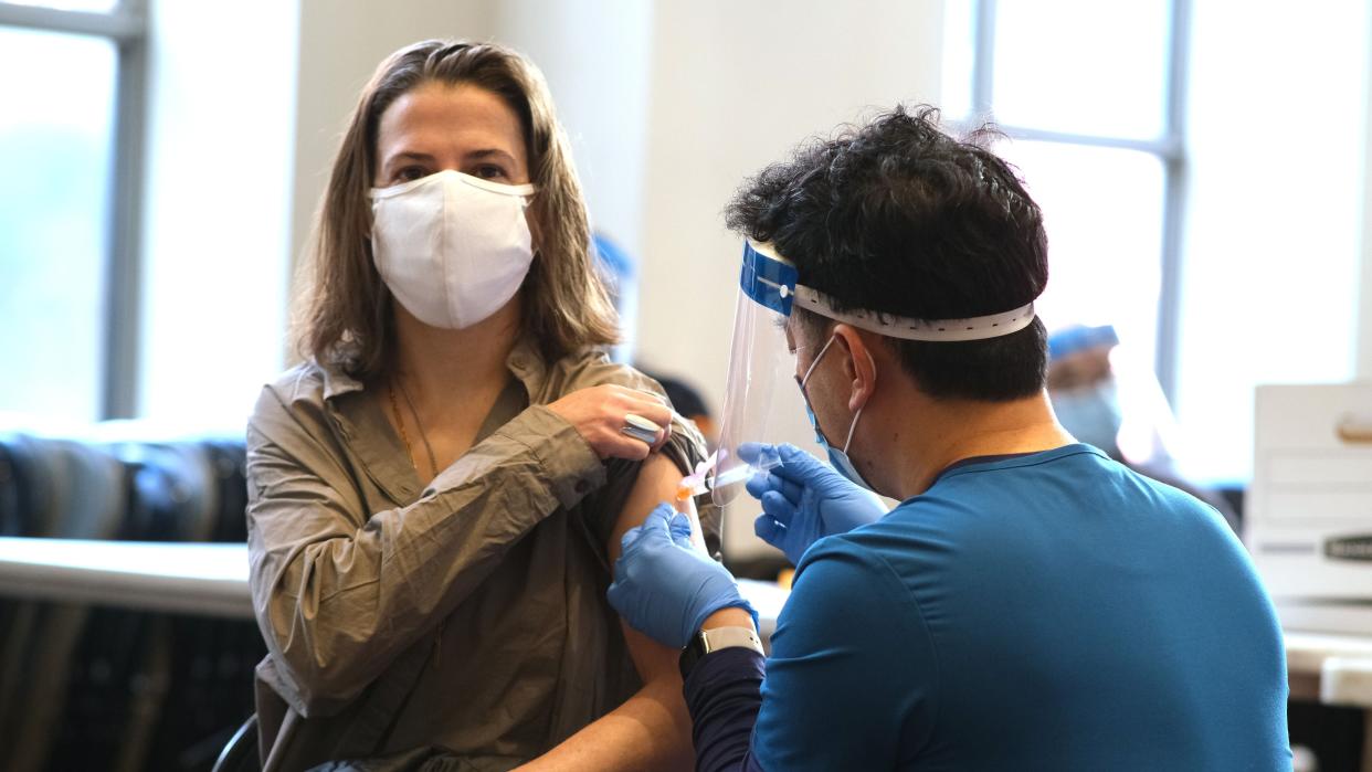 An FDNY Registered Nurse (RN) administer a dose of the Moderna COVID-19 vaccine to Martha Erekke a FDNY Certified First Responder (CFR) Firefighter at the Fire Department Headquarters in Brooklyn on Tuesday, Dec. 29, 2020.