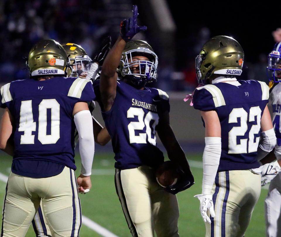 Salesianum's Yaheem Smith (20), shown here celebrating an interception with teammates, was named to the All-District 3A-1 team as a defensive back.