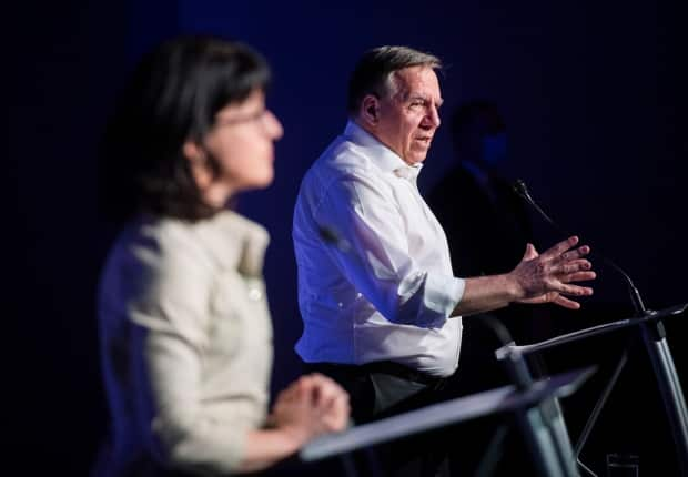 Legault and Sonia Lebel, Minister Responsible for Government Administration, speak during a news conference following a meeting with union leaders in Montreal, Sunday.