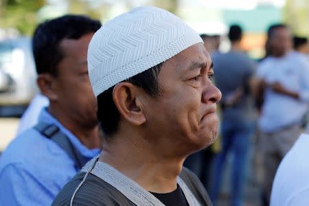 A Muslim man weeps while praying during Eid al-Fitr at a mosque inside city hall compound as government forces continue their assault against insurgents from the Maute group, who have taken over large parts of Marawi City , Philippines June 25, 2017. REUTERS/Jorge Silva