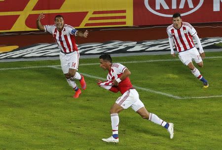 Paraguay's Lucas Barrios (bottom) celebrates with teammates after scoring against Argentina during their first round Copa America 2015 soccer match at Estadio La Portada de La Serena in La Serena, Chile, June 13, 2015. REUTERS/David Mercado