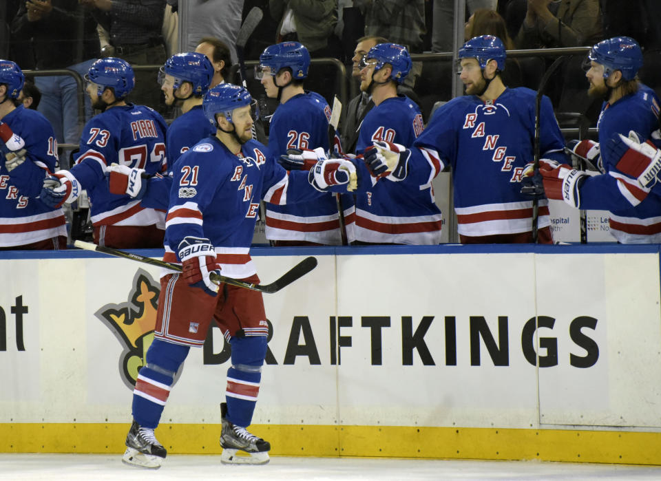 New York Rangers center Derek Stepan (21) celebrates at the bench after scoring during the first period of an NHL hockey game against the Pittsburgh Penguins, Sunday, April 9, 2017, at Madison Square Garden in New York. The Rangers won 3-2. (AP Photo/Bill Kostroun)