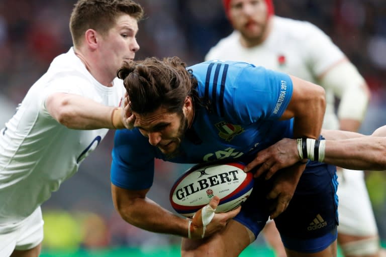 Italy's wing Giovanbattista Venditti dives over the line to score a try during the Six Nations international rugby union match between England and Italy at Twickenham stadium in London on February 26, 2017