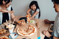 <p>Young Asian family enjoying dinner together, eating take-away pizza at home. Love and togetherness concept.</p> 