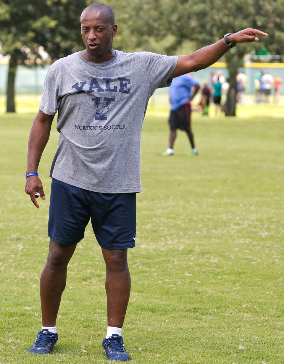 Rudy Meredith , Yale's women's head soccer coach, gives pointers to players during a scrimmage in Ocala, Florida. in September 2016.