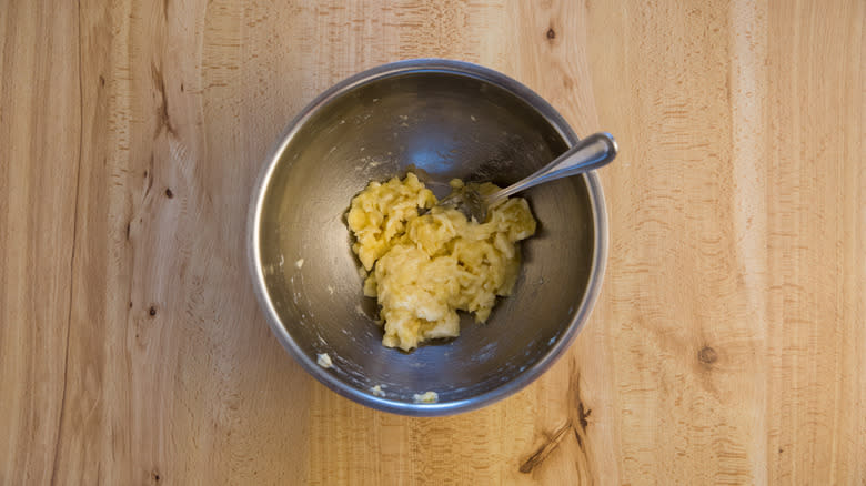 mashed bananas in metal bowl