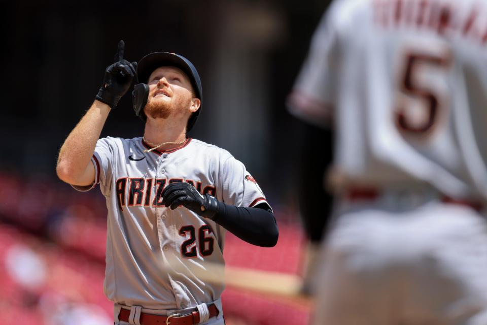 Arizona Diamondbacks' Pavin Smith points skyward as he crosses home plate after hitting a solo home run during the fifth inning of a baseball game against the Cincinnati Reds in Cincinnati, Thursday, June 9, 2022. (AP Photo/Aaron Doster)