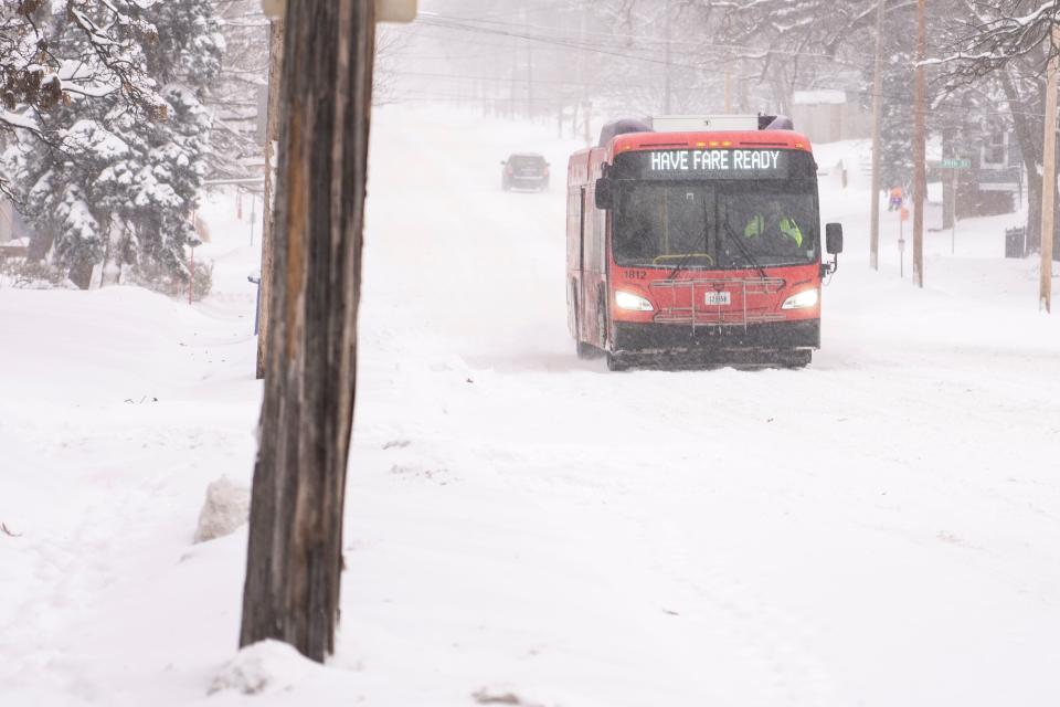 A DART bus drives along University Avenue after a second round of snow blankets the area on Friday, Jan. 12, 2024, in Des Moines.