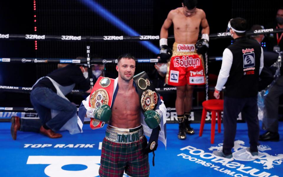 Josh Taylor poses with his belts after winning the fight against Apinun Khongsong. - REUTERS