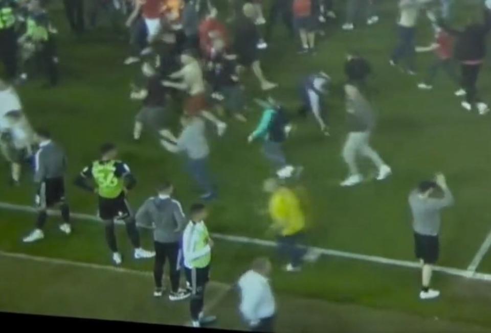 The man can be seen making a beeline for Sharp during the pitch invasion (Sky)