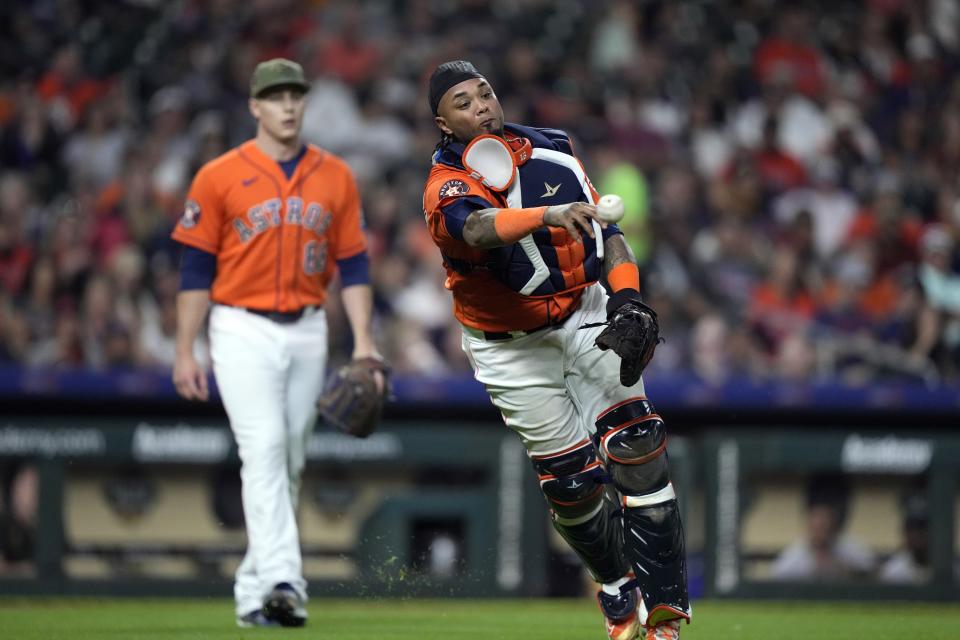 Houston Astros catcher Martin Maldonado throws to first after fielding a single by Oakland Athletics' Jace Peterson during the sixth inning of a baseball game Friday, May 19, 2023, in Houston. (AP Photo/David J. Phillip)