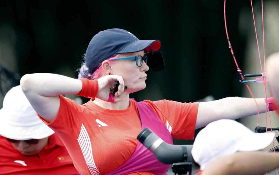 Britain's Jodie Grinham releases an arrow during the Paralympic Games in Paris on Thursday, Aug. 29, 2024. The British archer is competing while pregnant