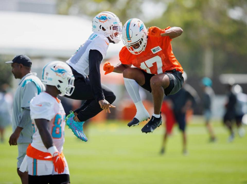 Los wide receivers de los Dolphins Jaylen Waddle (der.) y Lynn Bowden Jr. celebran tras una jugada en el campo de entrenamiento del equipo en el Baptist Health Training Complex en el Hard Rock Stadium, en Miami Gardens, Florida, el 28 de julio de 2022.