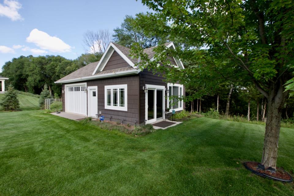 An outbuilding on the property is finished similarly to the home with wood, vaulted ceilings and lots of natural light.