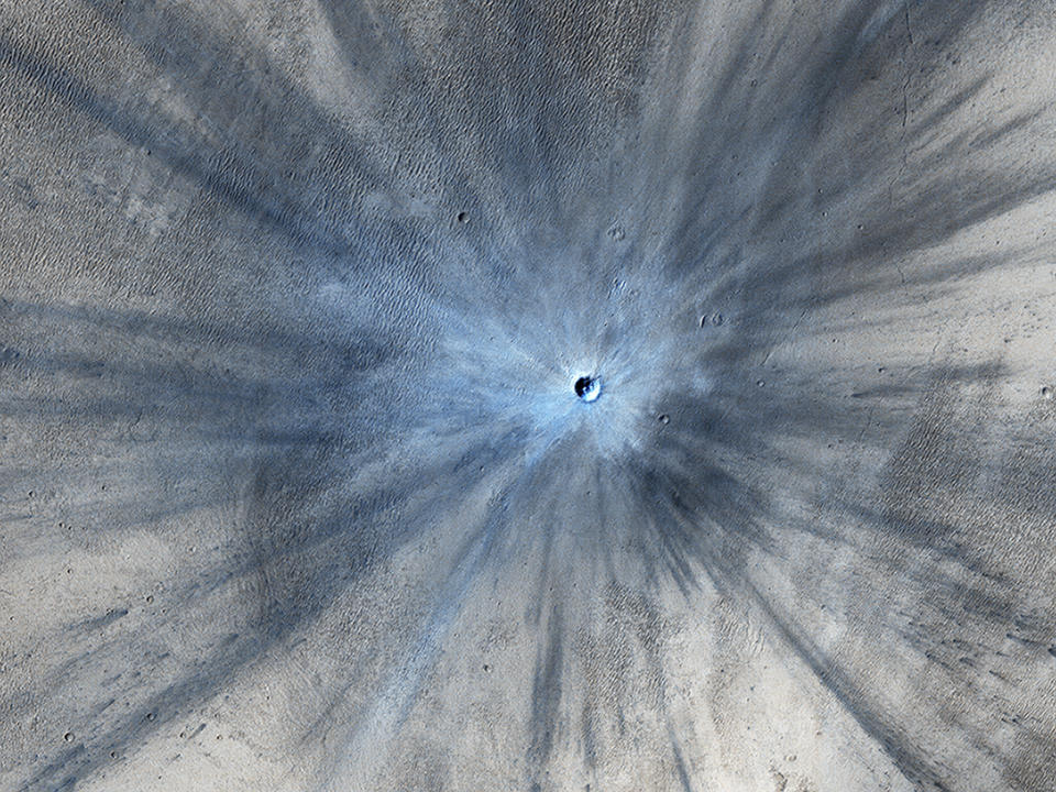 <p>An impact crater on Mars is seen in an image taken by the High Resolution Imaging Science Experiment (HiRISE) camera on NASA’s Mars Reconnaissance Orbiter on November 19, 2013 and released February 5, 2014. The crater spans approximately 100 feet (30 meters) in diameter and is surrounded by a large, rayed blast zone. (Photo: NASA/JPL-Caltech/Univ. of Arizona/Reuters) </p>