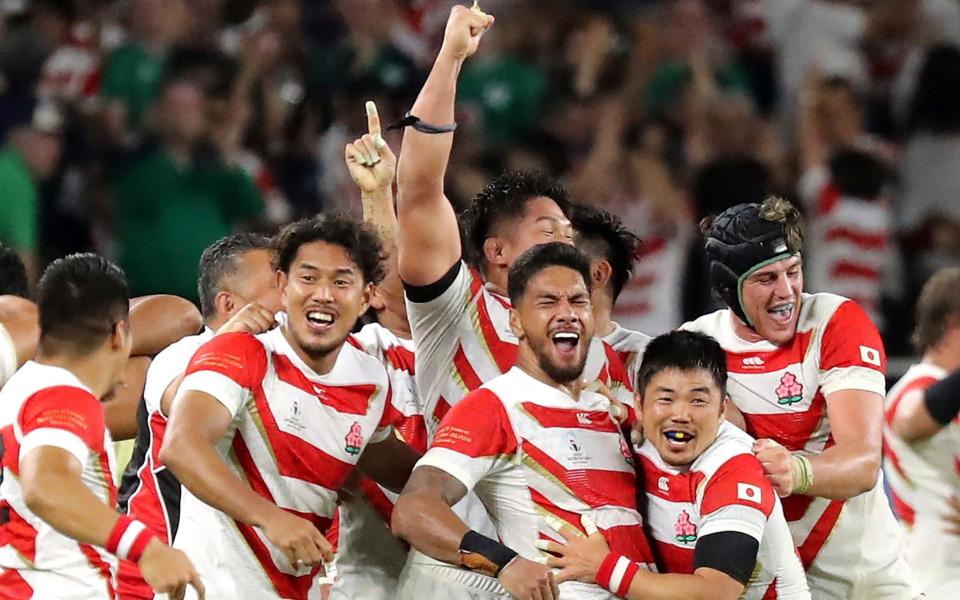 Japan's players celebrate after winning over Ireland in one of the biggest shock victories of the tournament so far. - AP