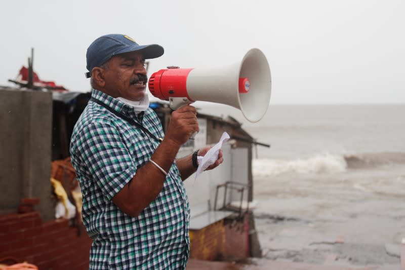 A Brihanmumbai Municipal Corporation (BMC) official makes an announcement to stay indoors over a loudspeaker before cyclone Nisarga makes its landfall, in Mumbai