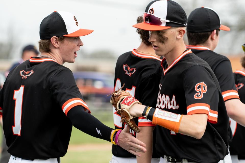 Pennsbury senior first baseman Sam Labrecque, right, is greeted by teammate Ryan Webber as he comes off the field during the Falcons' 6-0 victory over Bensalem on Tuesday.