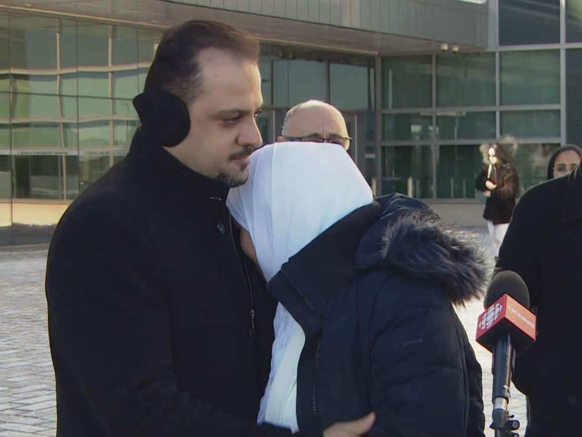 Diana Attar, centre, and her husband Mohammed Abu Marzouk, left, are seen in this photo from outside a Brampton courthouse earlier this year. The men convicted of aggravated assault in an attack against Abu Marzouk were sentenced to six years in prison Tuesday.  (Dean Gariepy/CBC - image credit)