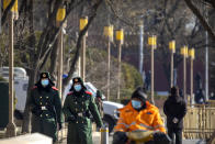 Chinese paramilitary police wearing face masks to protect against the spread of the coronavirus patrol along a street in Beijing, Saturday, Jan. 9, 2021. COVID vaccine shots will be free in China, where more than 9 million doses have been give to date, health officials in Beijing said Saturday. (AP Photo/Mark Schiefelbein)