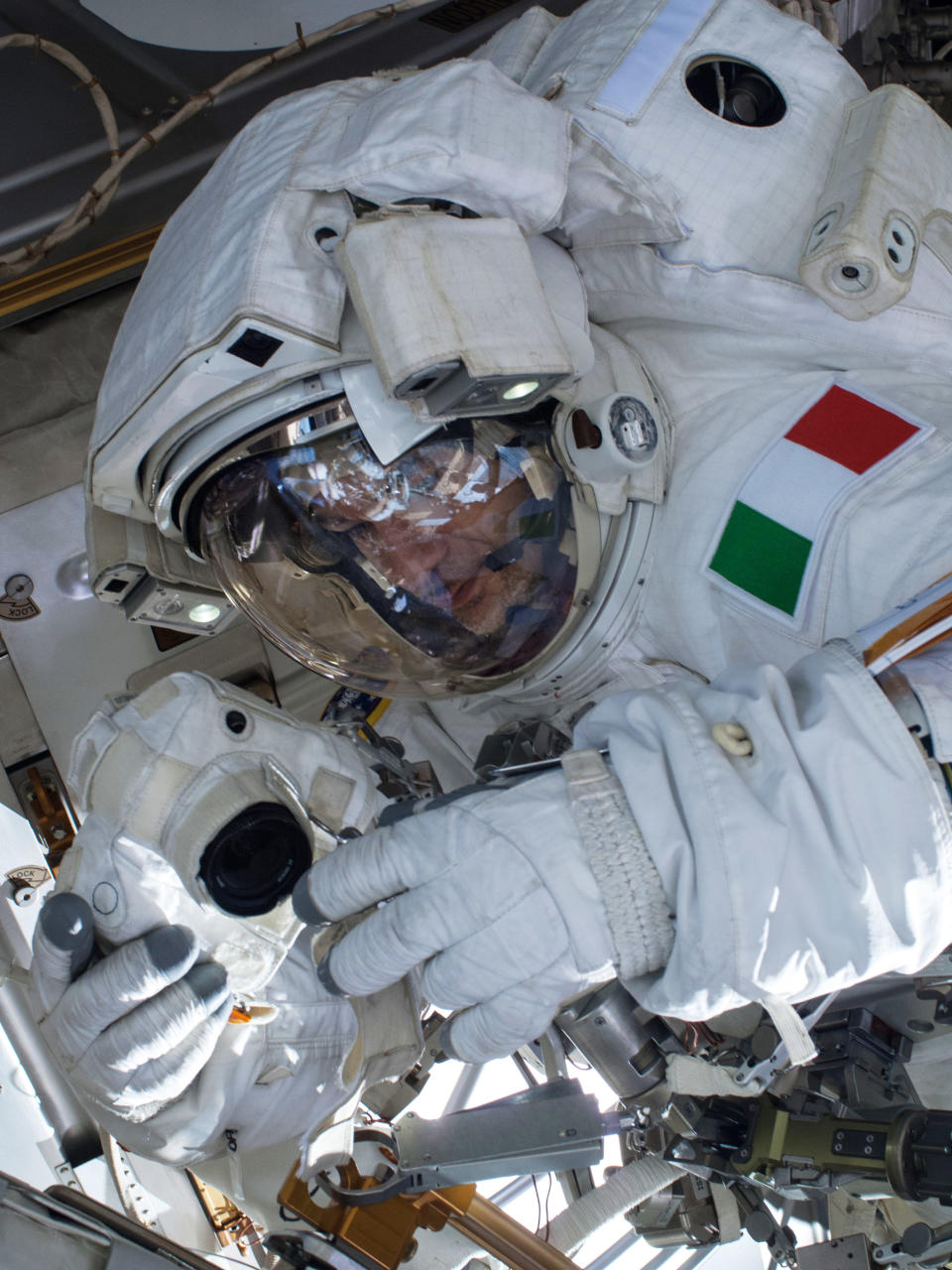 In this Tuesday, July 16, 2013 image provided by NASA, European Space Agency astronaut Luca Parmitano participates in a spacewalk outside the International Space Station. A final report issued Wedesday, Feb. 26, 2014 by NASA says it could have prevented the near-drowning of the spacewalking astronaut on July 16, 2013. According to the report, Parmitano's helmet had also leaked one week earlier at the end of his first spacewalk. The report says the space station team misdiagnosed the first failure and should have delayed the second spacewalk until the problem was understood. (AP Photo/NASA)
