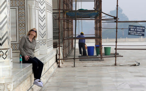 A foreign tourist admires the giant mausoleum as work continues - Credit: AP