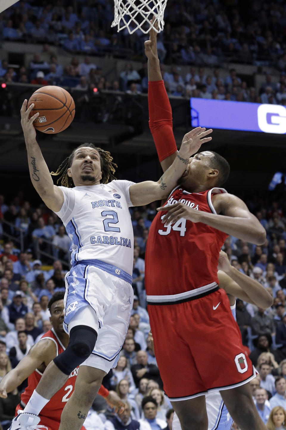 North Carolina guard Cole Anthony (2) drives to the basket against Ohio State forward Kaleb Wesson (34) during the first half of an NCAA college basketball game in Chapel Hill, N.C., Wednesday, Dec. 4, 2019. (AP Photo/Gerry Broome)