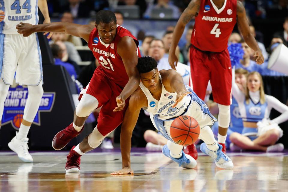 <p>Manuale Watkins #21 of the Arkansas Razorbacks battles for a loose ball with Isaiah Hicks #4 of the North Carolina Tar Heels in the second half during the second round of the 2017 NCAA Men’s Basketball Tournament at Bon Secours Wellness Arena on March 19, 2017 in Greenville, South Carolina. (Photo by Gregory Shamus/Getty Images) </p>