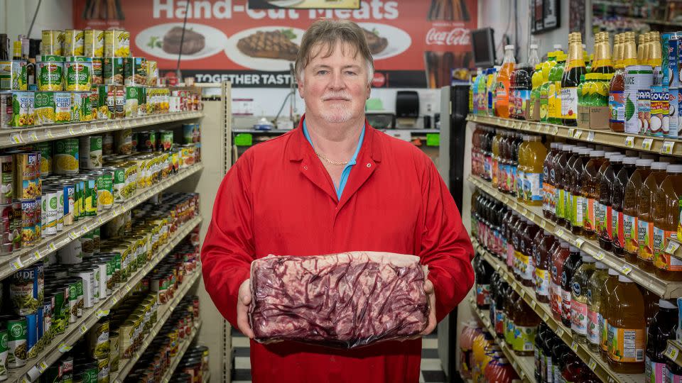 Mike Moatts, the butcher at Elberta Grocery in Elberta, Alabama, which also serves Indian food on Mondays — courtesy of one of its cashiers, Dhinal Patel. - Kate Medley