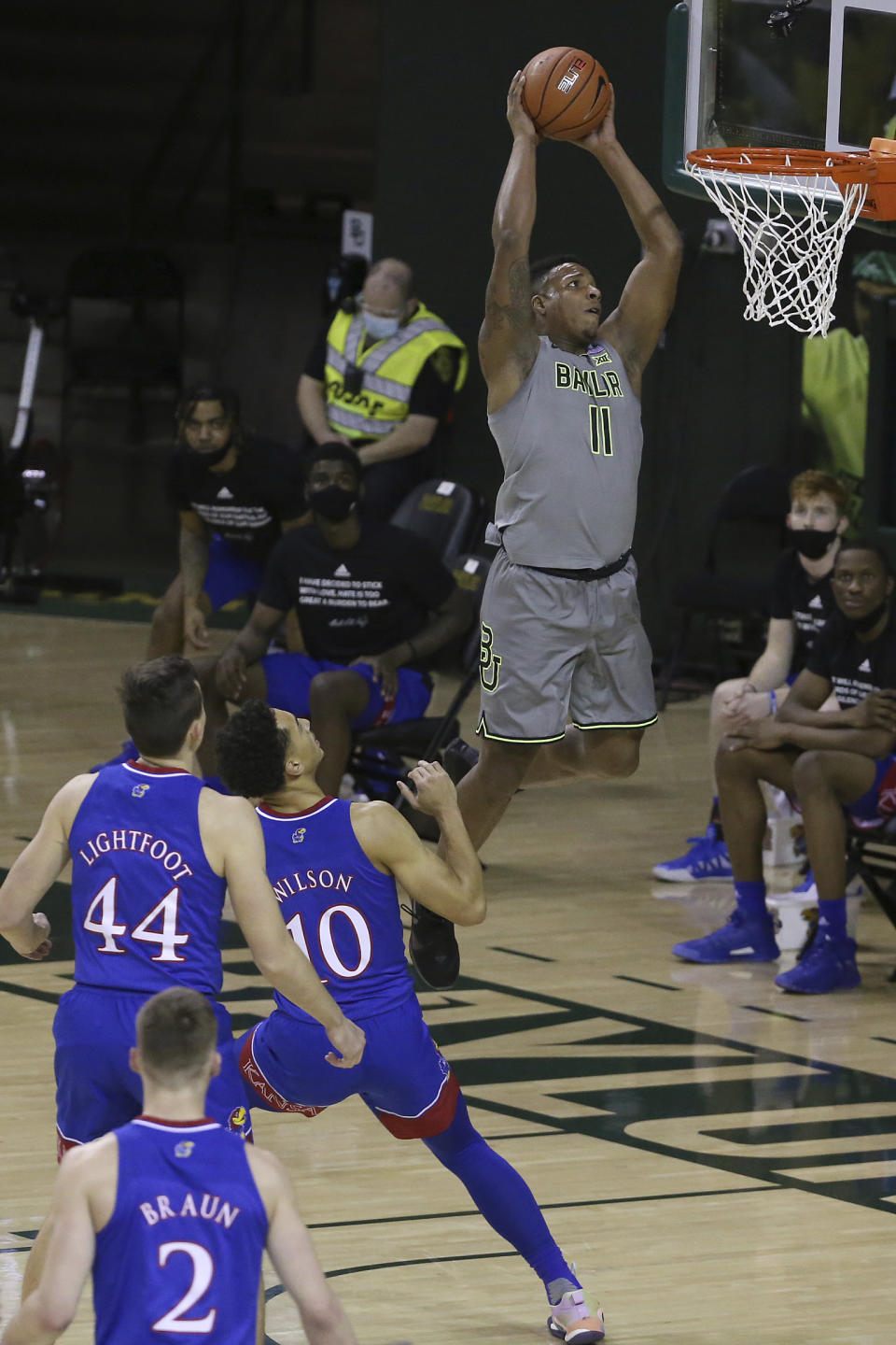 Baylor guard Mark Vital (11) scores against Kansas forwards Mitch Lightfoot (44) and Jalen Wilson (10) in the first half of an NCAA college basketball game, Monday, Jan. 18, 2021, in Waco, Texas. (AP Photo/Jerry Larson)