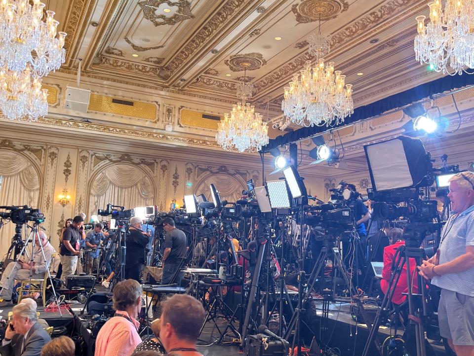 TV outlets set up their equipment on risers.