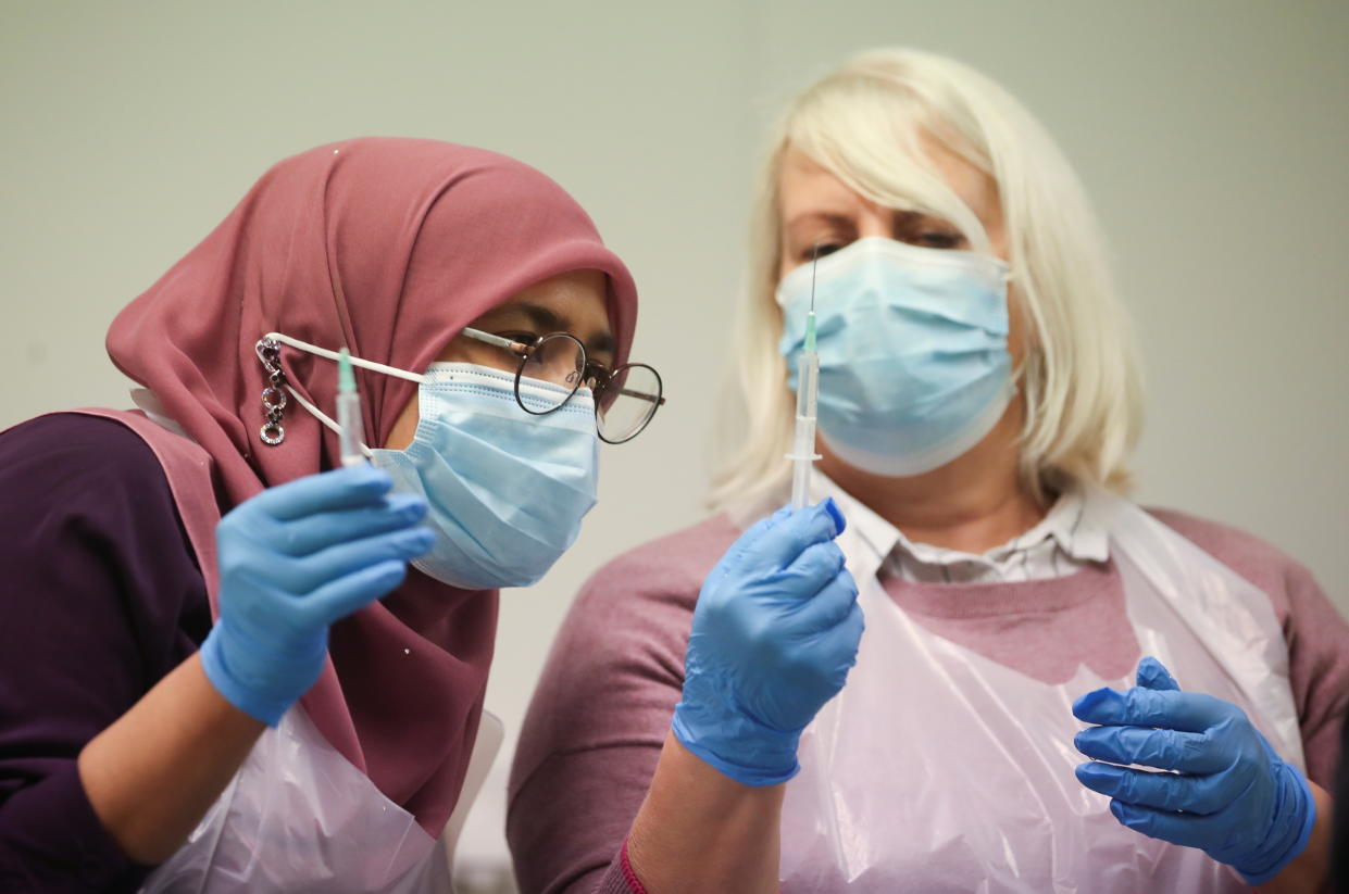 Pharmacy staff members prepare COVID-19 vaccines, at STEAM Museum, amid the outbreak of the coronavirus disease (COVID-19) in Swindon, Britain, January 21, 2021. REUTERS/Peter Cziborra