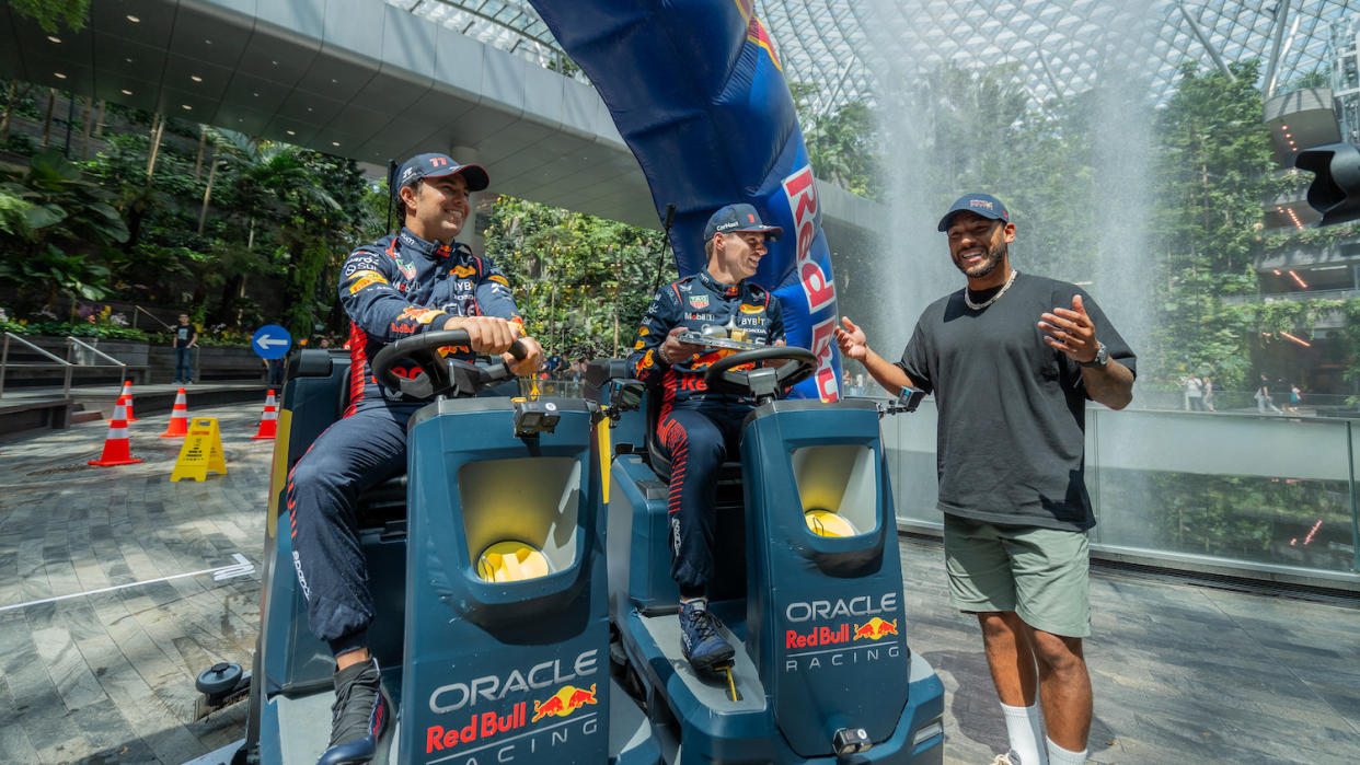 Red Bull Racing drivers Sergio Perez (left) and Max Verstappen take part in the Cleaning Challenge at Jewel Changi Airport. (PHOTO: Jon Ho/Red Bull Content Pool)