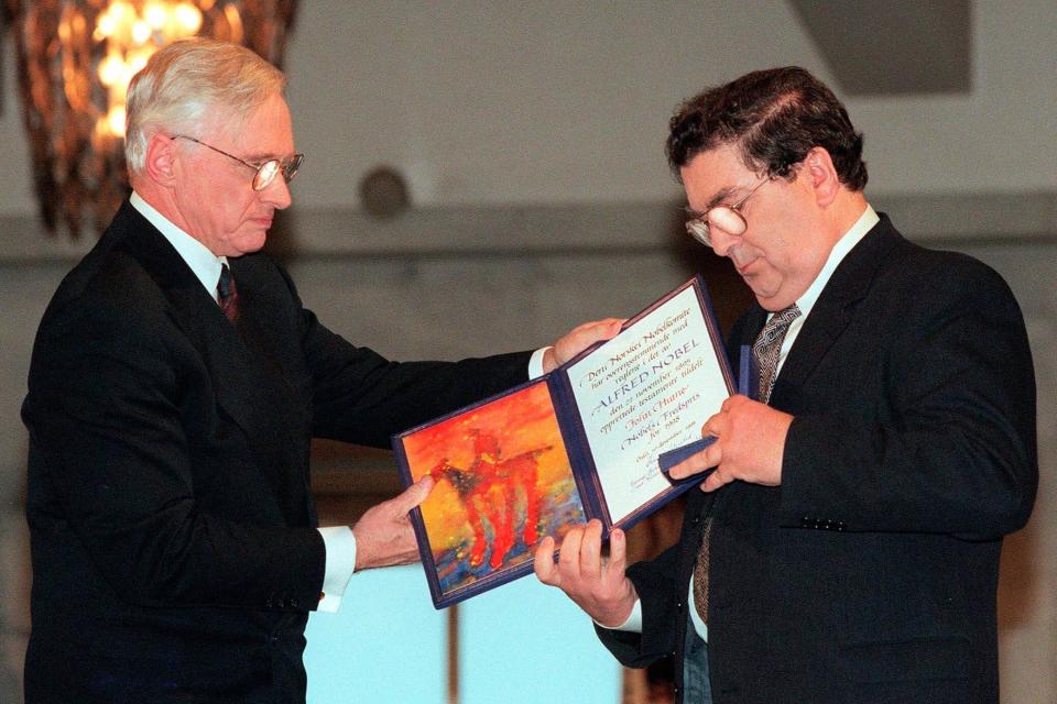 Hume receiving his Nobel Peace Prize diploma which he received from Francis Sejersted, left, chairman of the Norwegian Nobel Peace Prize Committee during the award ceremony in Oslo Town Hall - Bjoern Sigurdsoen/NTB/POOL