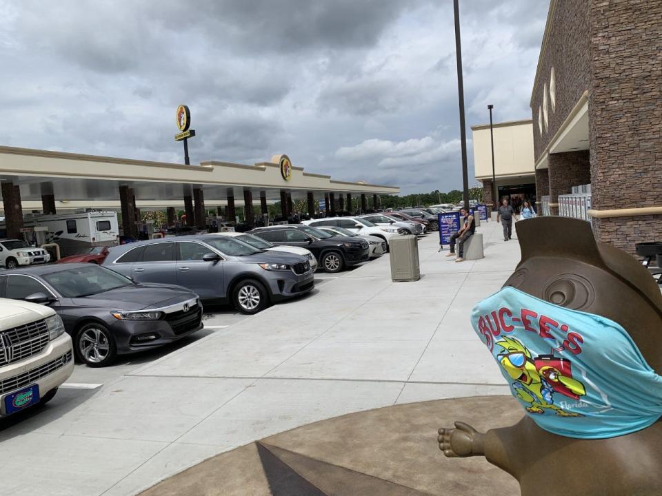 A statue of the Buc-ee the Beavor mascot can be seen wearing a face mask in the parking lot next to the refueling area for the 104-pump supersized gas station next to the Interstate 95/LPGA Boulevard interchange in Daytona Beach on Friday, April 16, 2021.