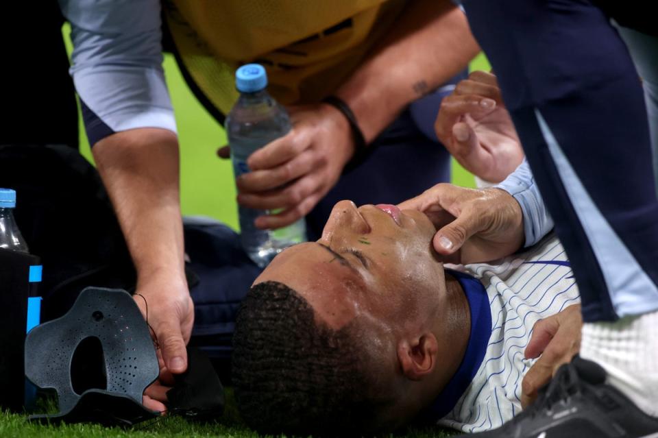 Kylian Mbappe’s face is inspected after his mask was struck with the ball (Getty Images)